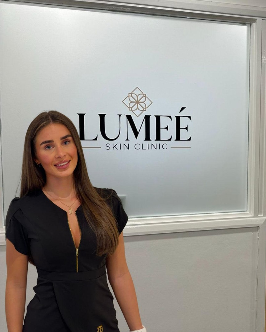 Inside Lumeé Skin Clinic, by the branded window